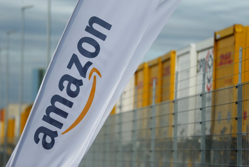 © Reuters. Banderas con el logotipo de Amazon y los tráilers del correo alemán Deutsche Post DHL Group se muestran en la foto fuera del nuevo centro logístico de Amazon en Dortmund
