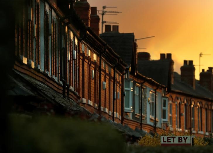 © Reuters. An estate agents board is seen in front of a row of terraced houses in Altrincham northern England.