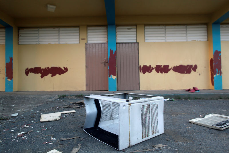 © Reuters. A broken air conditioner is seen outside a shut-down elementary school, in Toa Baja