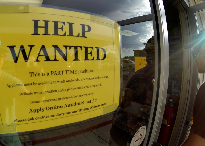 © Reuters. FILE PHOTO: A help wanted sign is posted on the door of a gas station in Encinitas California