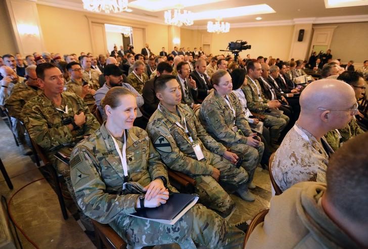© Reuters. FILE PHOTO - U.S. Army members and multinational officials attend the third annual international conference on countering Islamic State propaganda in Baghdad