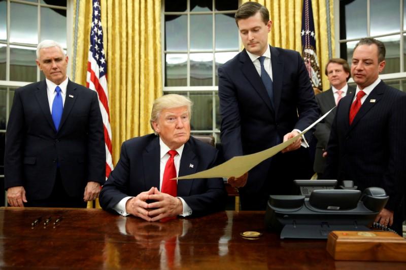 © Reuters. FILE PHOTO: Porter hands document to Trump during signing ceremony in the Oval Office in Washington