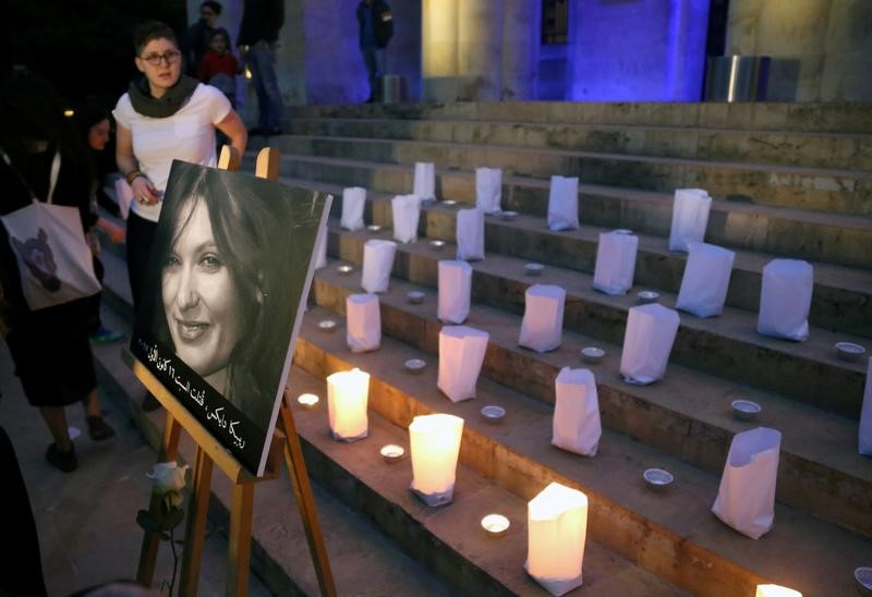 © Reuters. FILE PHOTO - A photo of the British embassy worker, Rebecca Dykes, is seen during a candlelight sit-in organised by activists in Beirut