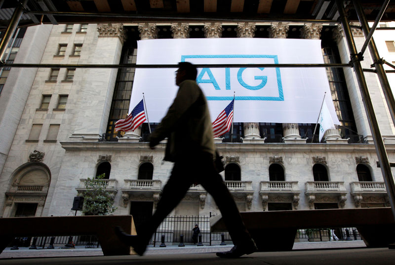 © Reuters. FILE PHOTO: A banner for American International Group Inc hangs on the facade of the New York Stock Exchange