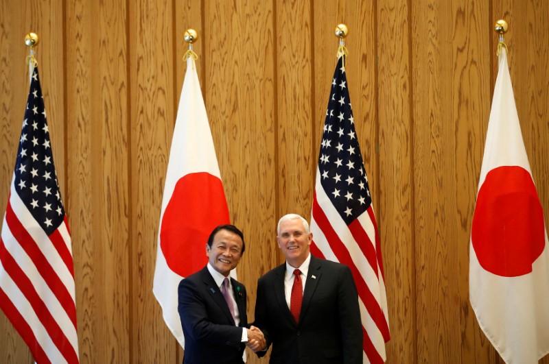 © Reuters. U.S. Vice President Mike Pence is welcomed by Japan's Deputy Prime Minister Taro Aso in Tokyo