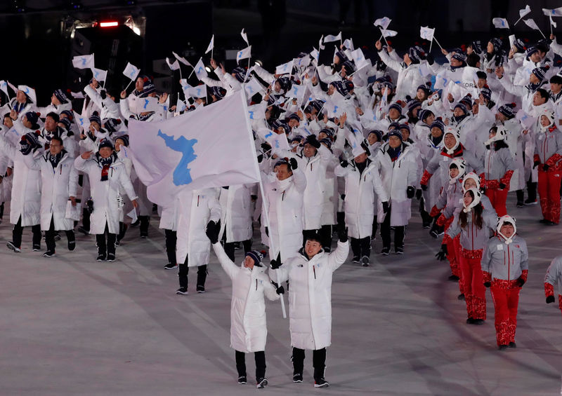 © Reuters. Hwang Chung Gum and Won Yunjong da Coreia carregam bandeira nacional durante cerimônia de abertura da Olimpíada de Inverno de Pyeongchang