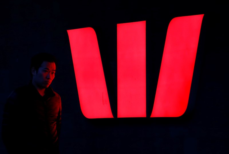 © Reuters. A man walks past an illuminated logo for Australia's Westpac Bank in Sydney