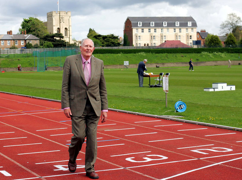 © Reuters. FILE PHOTO: Sir Roger Bannister walks over the same finish line at the Iffley Road running track in Oxford that he crossed fifty years ago when he was the first man to run the sub four minute mile
