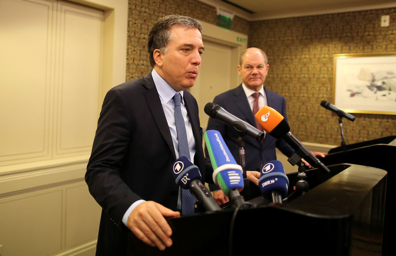 © Reuters. Argentina's Treasury Minister Nicolas Dujovne attends a news conference next to Germany's Finance Minister Olaf Scholz during the 2018 G20 Conference in Buenos Aires