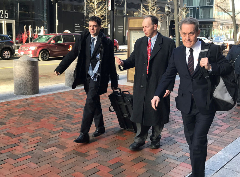 © Reuters. FILE PHOTO: Former Georgeson LLC employee Michael Sedlak and defense attorney David Spears enter the federal courthouse in Boston