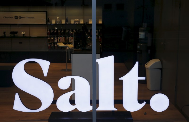 © Reuters. The logo of Swiss mobile telecommunications operator Salt. is pictured in a shop in the company headquarters in Renens