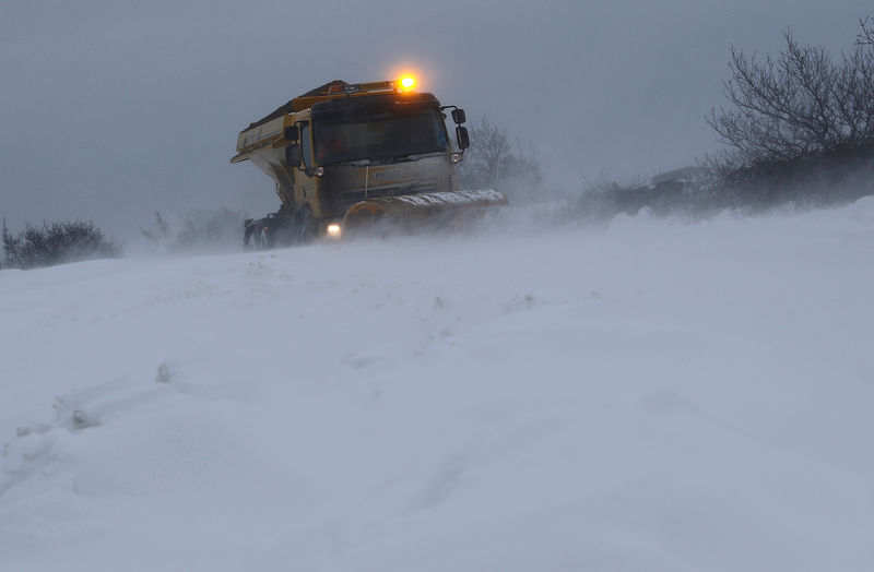 © Reuters. FILE PHOTO: A snow plough clears a road in Coalville