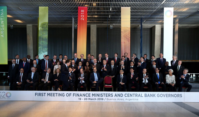 © Reuters. Argentina's Secretary of Treasury Dujovne is applauded as he arrives for the official photo at the G20 Meeting of Finance Ministers in Buenos Aires