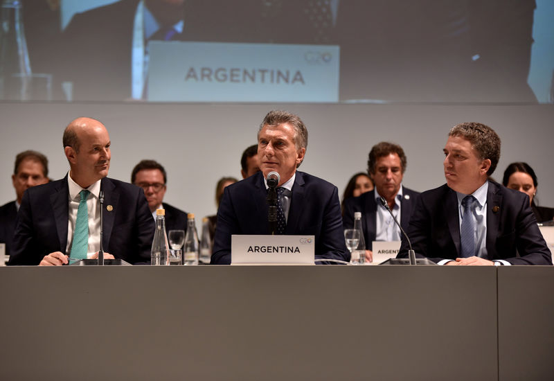 © Reuters. Argentina's President Mauricio Macri speaks alongside Finance Minister Dujovne and Central Bank President Sturzenegger at the G20 Meeting of Finance Ministers in Buenos Aires