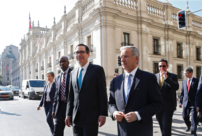 © Reuters. U.S. Treasury Secretary Steve Mnuchin walks next to Chile's Finance Minister Felipe Larrain after a meeting at La Moneda Presidential Palace in Santiago