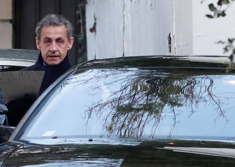 © Reuters. Former French President Nicolas Sarkozy enters his car as he leaves his house in Paris