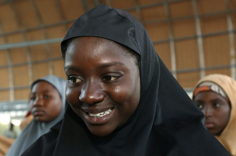 © Reuters. Some of the newly released Dapchi schoolgirls wait for boarding a plane at the air force base in Maiduguri