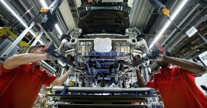 © Reuters. Employees of German car manufacturer Porsche work on a sports car at the Porsche factory in Stuttgart-Zuffenhausen