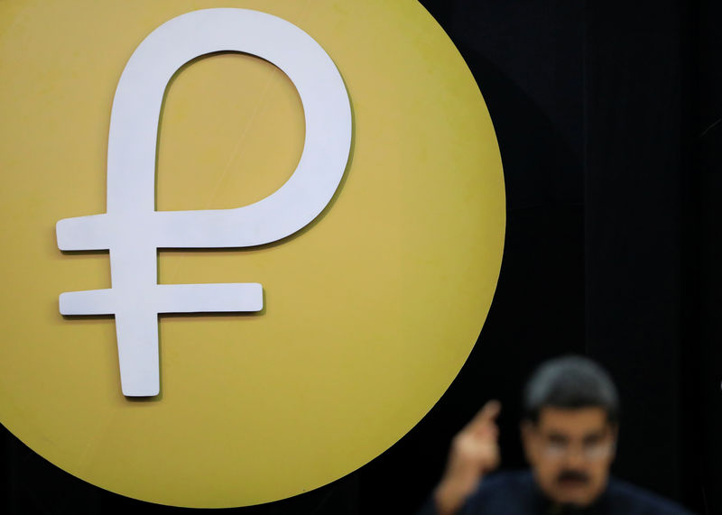 © Reuters. The Venezuelan cryptocurrency "Petro" logo is seen as Venezuela's President Maduro speaks during a meeting in Caracas