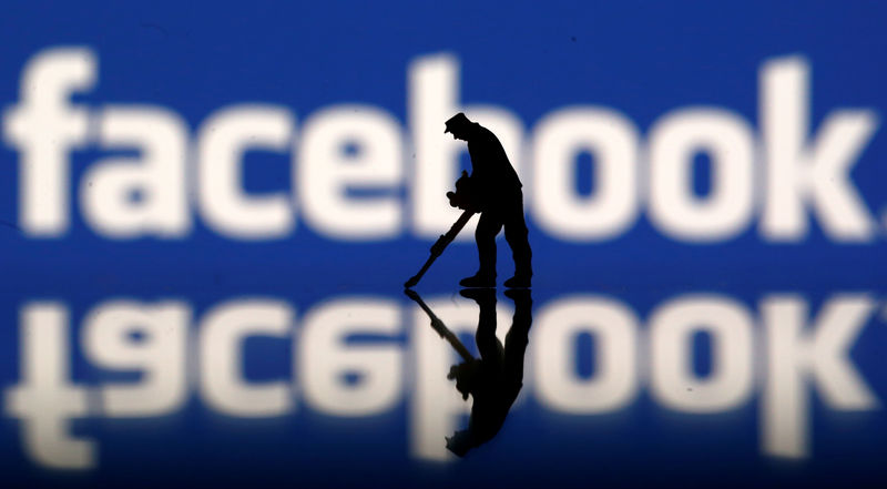 © Reuters. A figurine is seen in front of the Facebook logo in this illustration