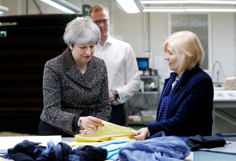 © Reuters. Britain's Prime Minister Theresa May visits textile producers Alex Begg during a tour of the United Kingdom, timed to coincide with one year until the United Kingdom leaves the European Union, in Ayr, Scotland