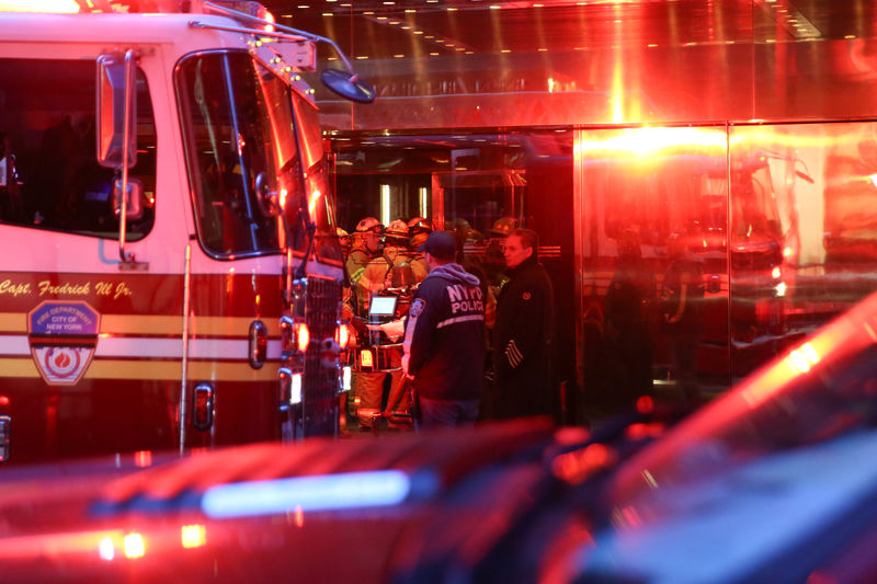 © Reuters. First responders work on a fire in a residential unit at Trump tower in the Manhattan borough of New York City