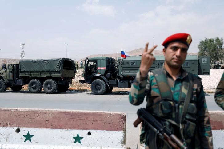 © Reuters. Russian flag is seen on a military vehicle, at the entrance of Wafideen camp in Damascus