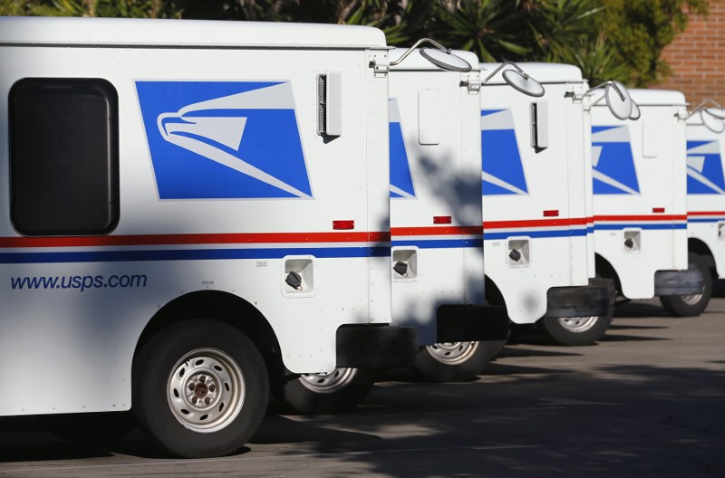 © Reuters. U.S. postal service trucks sit parked at the post office in Del Mar, California
