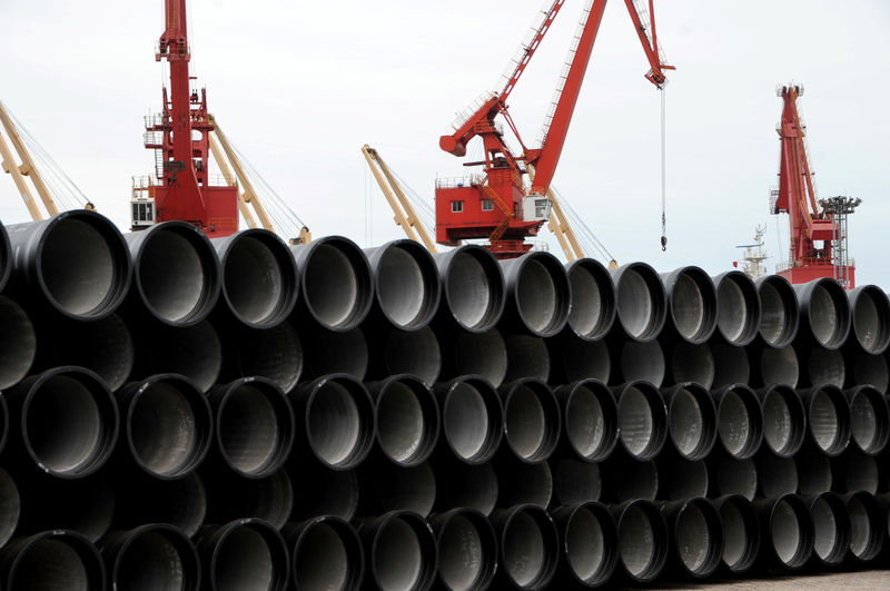 © Reuters. Steel pipes are seen piled up at a port in Lianyungang