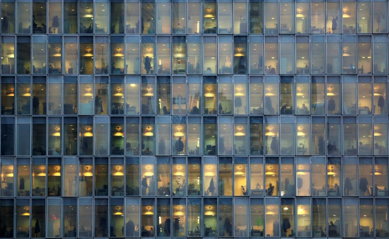 © Reuters. Lights are on as people work in their offices in a skyscraper in downtown Milan