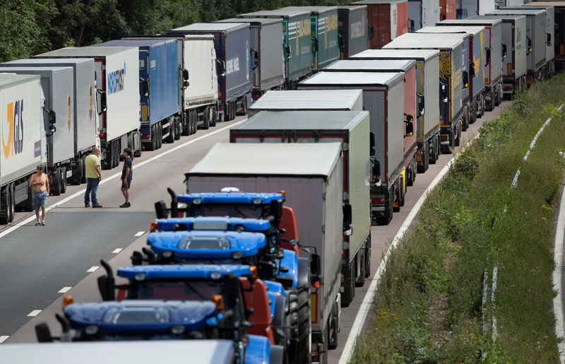 © Reuters. FILE PHOTO: Lorries are parked on the M20 motorway as park of Operation Stack in southern England