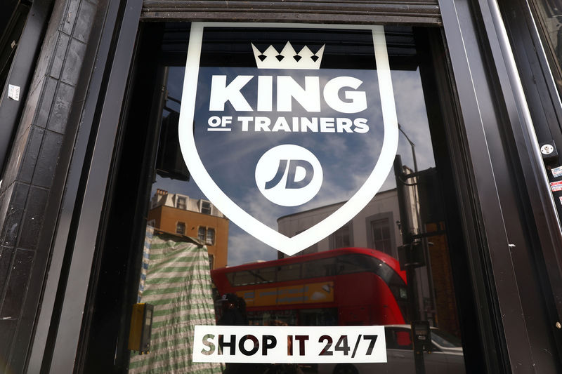 © Reuters. FILE PHOTO: A sign for a JD Sports store is displayed in a window in London
