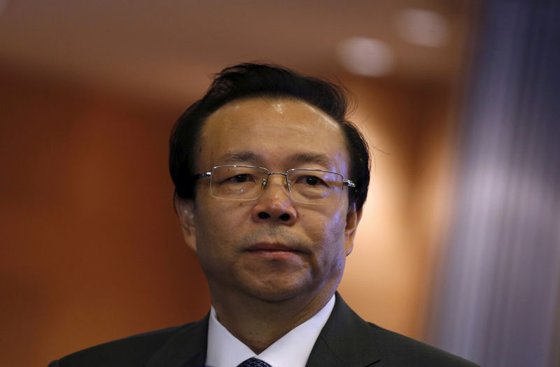 © Reuters. FILE PHOTO - China Huarong Asset Management Co Chairman Lai Xiaomin listens to a question from a reporter during the debut of the company at the Hong Kong Exchanges in Hong Kong