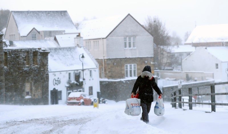 © Reuters. A resident carries home their shopping near Sterling Castle, Scotland