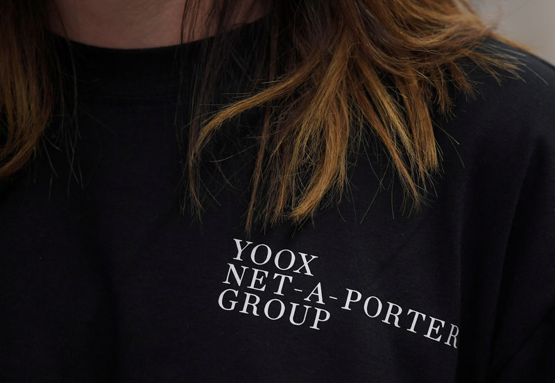 © Reuters. FILE PHOTO: Branding is seen on the clothing of an employee of online clothing retailer Yoox Net-A-Porter at their Tech Hub premises in White City in London