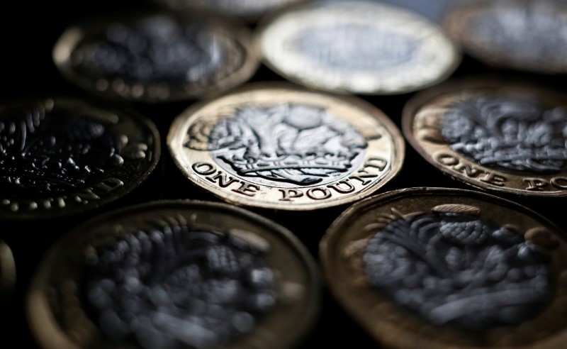 © Reuters. Pound coins are seen in the photo illustration taken in Manchester, Britain