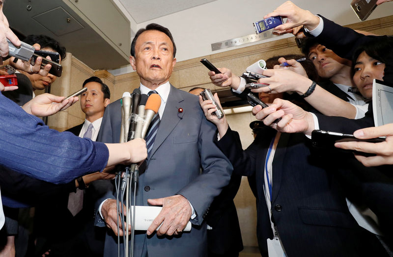 © Reuters. Japan's DPM and Finance Minister Aso speaks to reporters at the Finance Ministry in Tokyo