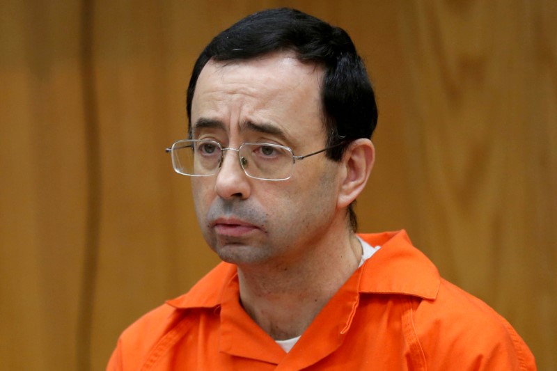 © Reuters. FILE PHOTO: Nassar a former team USA Gymnastics doctor listens to victims impact statements during his sentencing Charlotte