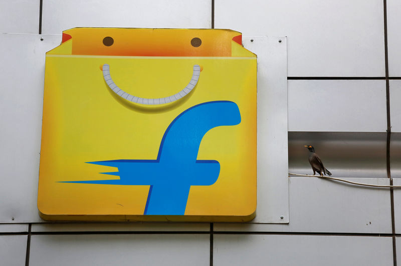 © Reuters. A Common myna sits next to the logo of India's e-commerce firm Flipkart installed on the company's office in Bengaluru