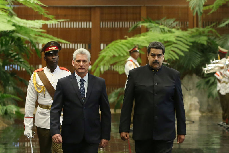 © Reuters. Cuban President Miguel Diaz-Canel and Venezuela's President Nicolas Maduro review an honour guard during a ceremony at the Revolution Palace in Havana