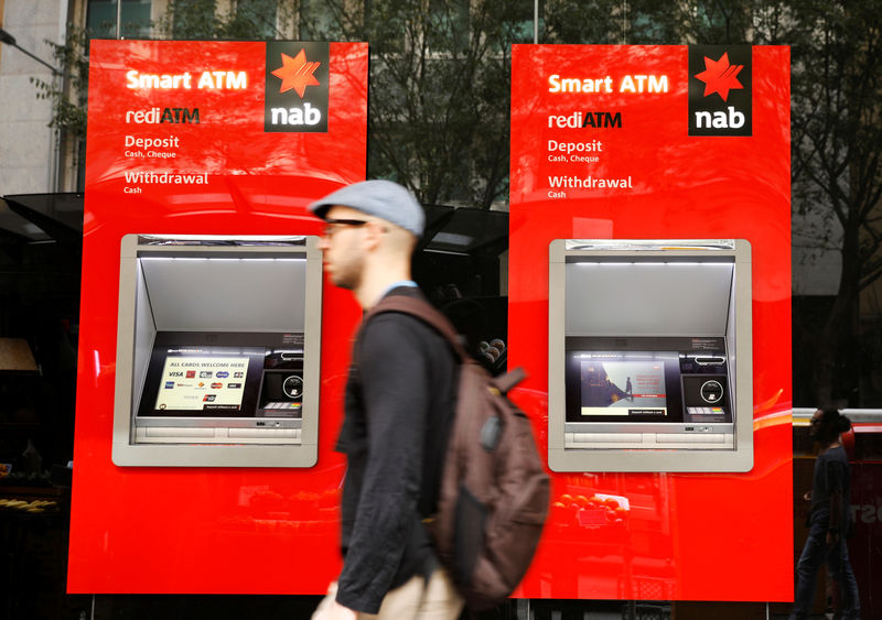 © Reuters. A man walks past ATM machines at a National Australia Bank branch in Sydney, Australia