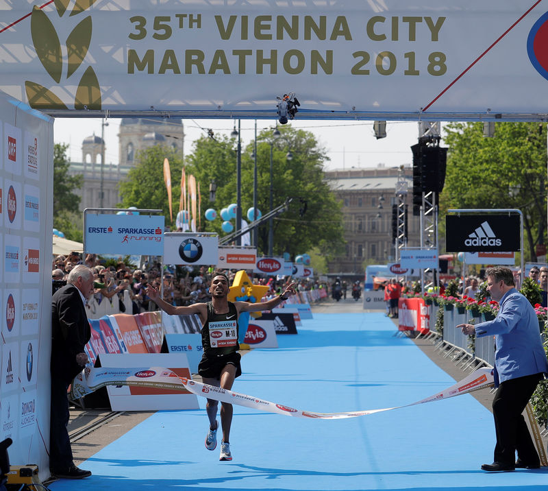 © Reuters. Bounasser of Morocco crosses the finish line to win the Vienna City Marathon in Vienna