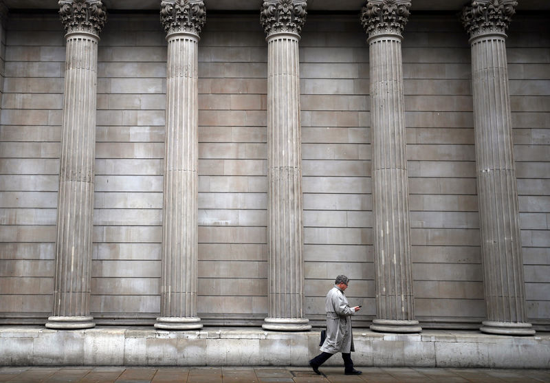 © Reuters. A man walks past the Bank of England in London
