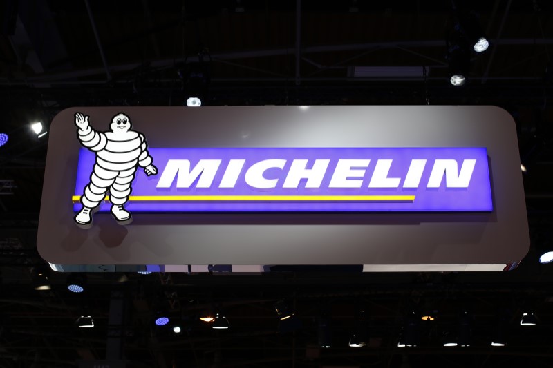 © Reuters. A sign with the logo of French tyre maker Michelin, with a Bibendum, the Michelin Man mascot, is pictured on media day at the Paris Mondial de l'Automobile