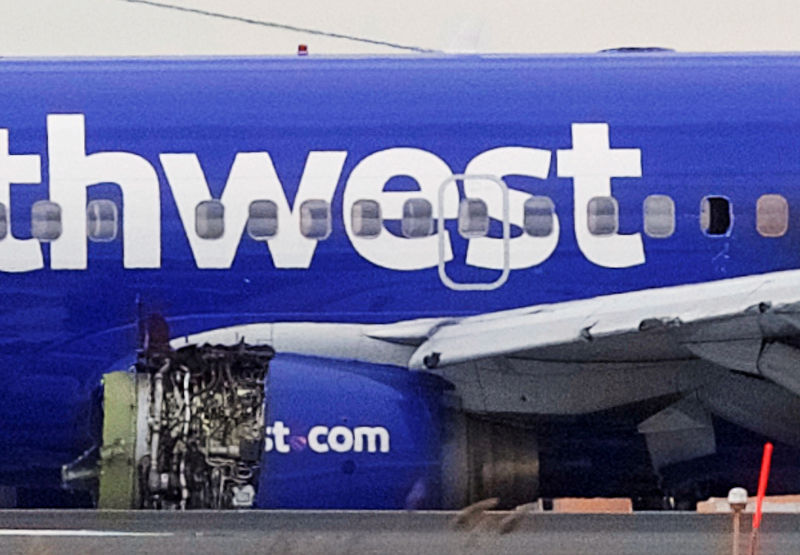 © Reuters. Emergency personnel monitor the damaged engine of Southwest Airlines Flight 1380, which diverted to the Philadelphia International Airport this morning, in Philadelphia, Pennsylvania