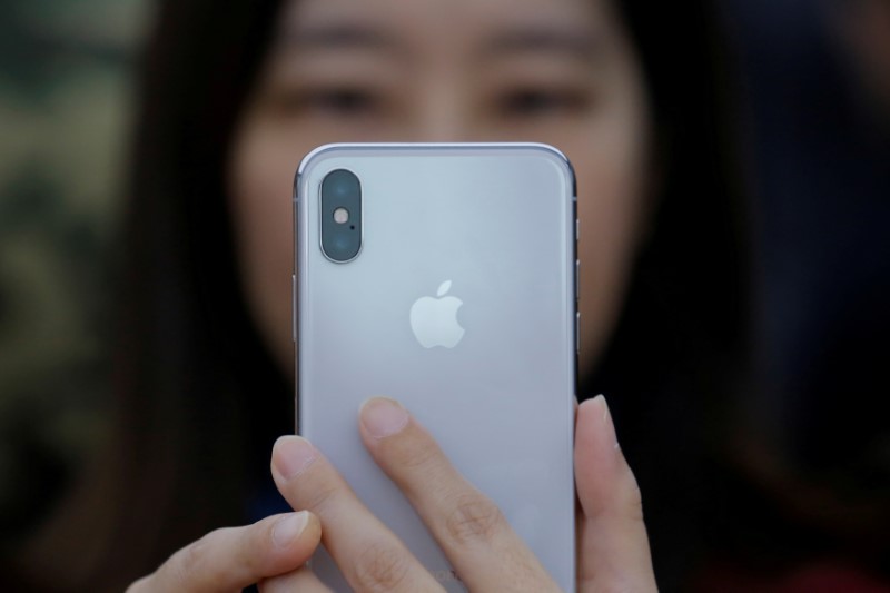 © Reuters. FILE PHOTO: An iPhone X is seen on a large video screen in the new Apple visitor centre in Cupertino