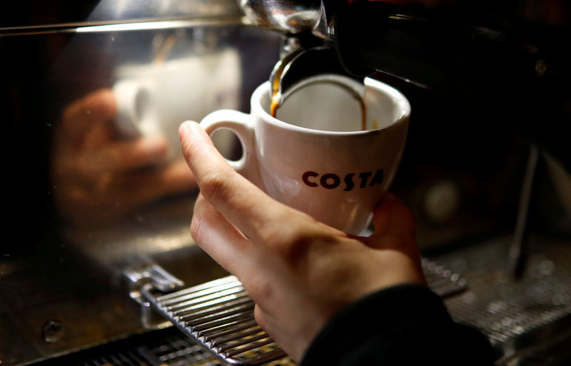 © Reuters. FILE PHOTO: A barista makes a cup of coffee at a branch of Costa Coffee near Manchester