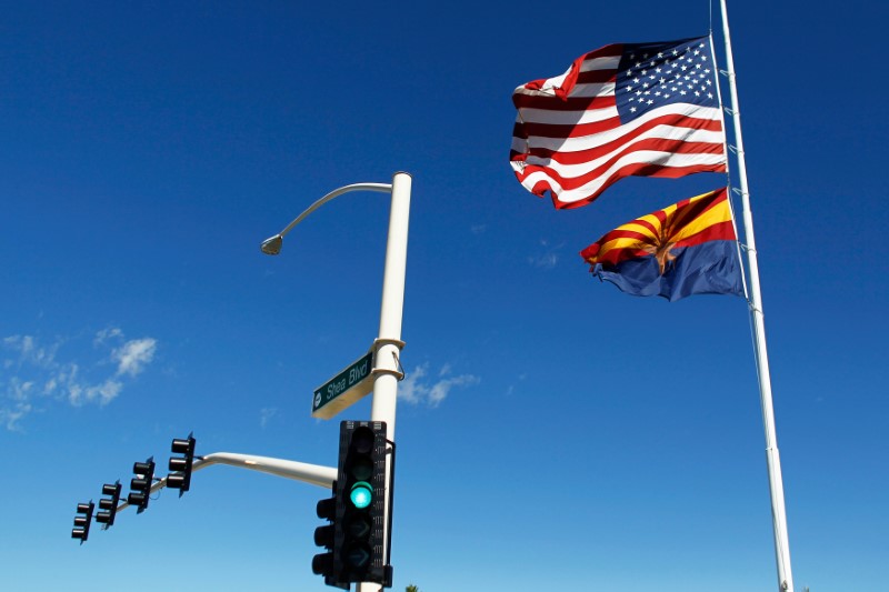 © Reuters. The U.S. and Arizona flags flutter in the wind in Fountain Hills