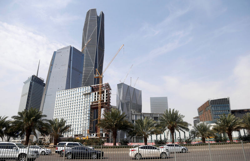 © Reuters. FILE PHOTO: Cars drive past the King Abdullah Financial District, north of Riyadh