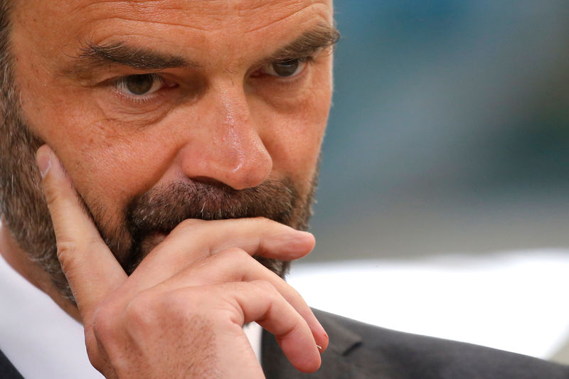 © Reuters. French Prime Minister Edouard Philippe listens to a speech about the government's recycling program during a visit at the Groupe Seb Moulinex factory in Mayenne